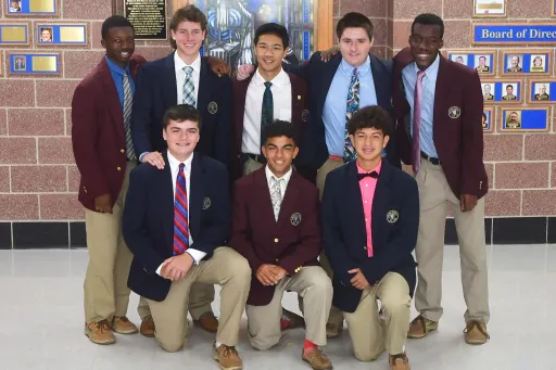 Several students from a few years ago show off the DeMatha uniform in the main entrance.