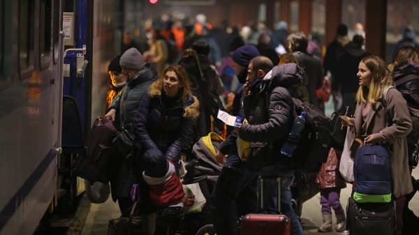 Ukrainian refugees board a train bound for Poland in the midst of the Russian invasion. Photo credit: Sean Gallup/Getty Images, 2022