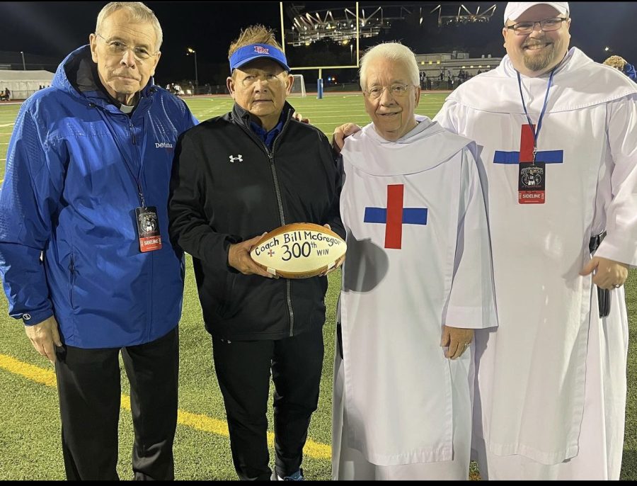 Coach Mcgregor after the win, poses with Father Damian, Father James, and Father Josh (left to right)