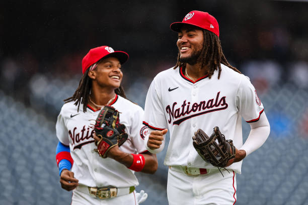 WASHINGTON, DC - AUGUST 08: CJ Abrams #5 and James Wood #29 of the Washington Nationals react during the second inning against the San Francisco Giants at Nationals Park on August 8, 2024 in Washington, DC. (Photo by Scott Taetsch/Getty Images)