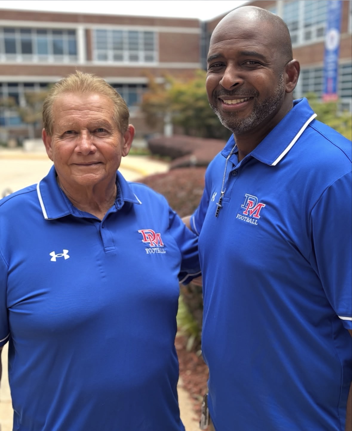 Bryce Bevill '90 and Coach Bill McGregor pose for a picture. 